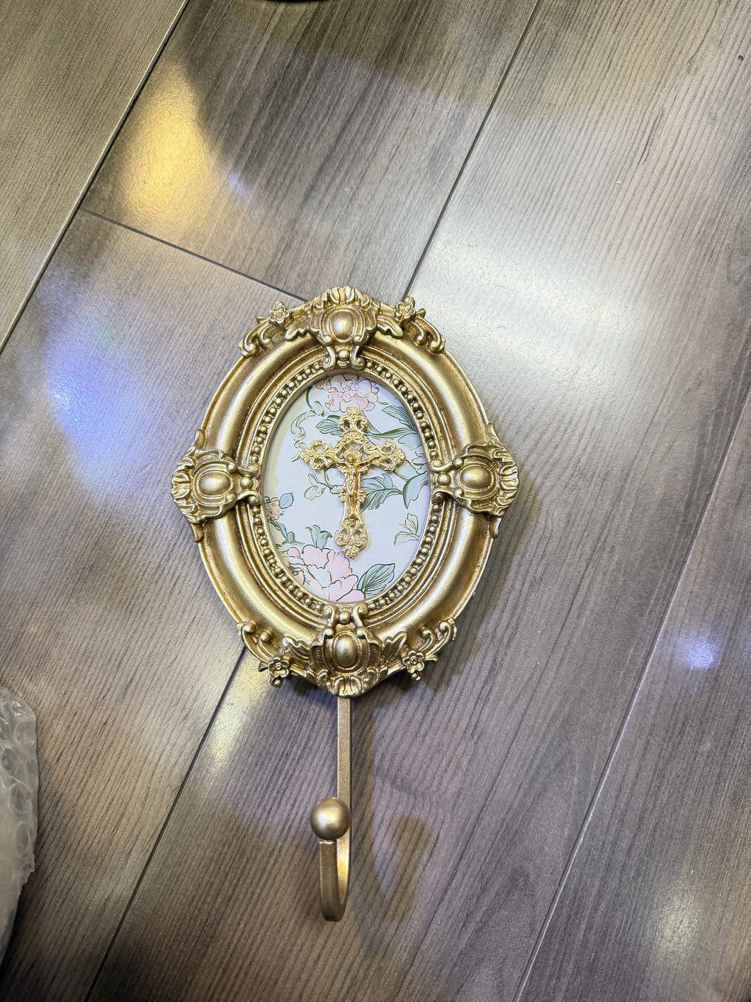 Crucifix on Pink Floral Background set on Vintage Wall Hook