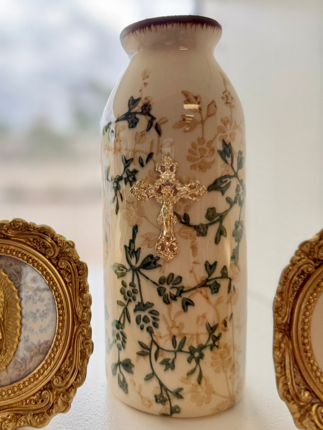 Crucifix on green/ beige floral ceramic tall vase